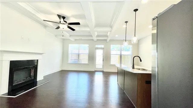 a view of a kitchen with a sink stainless steel appliances and cabinets