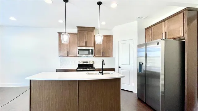 a kitchen with a sink a stove and cabinets