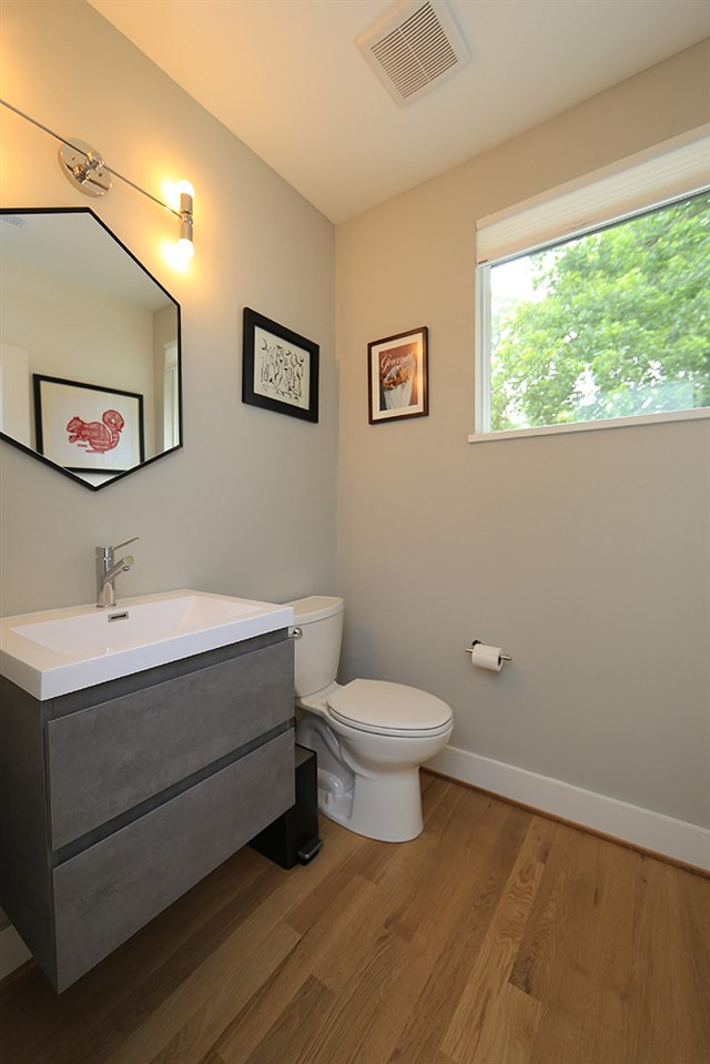 211 South Pettigrew Street Raleigh, NC 27610 - Photo 18 of 29 Half Bath with custom sink fixture and countertop, window and hardwood floors. Half Bath