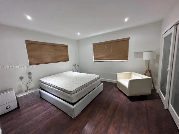 a bedroom with a bed and a couch