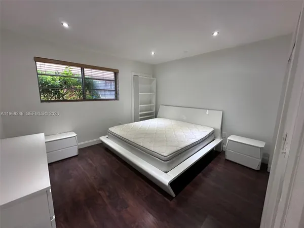 a bedroom with a bed and a night stand