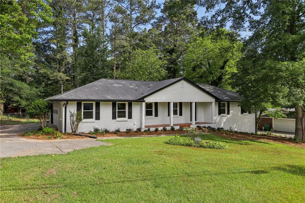 5421 Brownlee Road Southwest, Unit 1 Stone Mountain, GA 30087 - Photo 1 of 1 a front view of a house with a yard