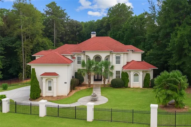 a front view of a house with a garden
