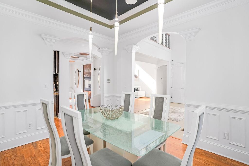 105 Ensley Point Fayetteville, GA 30214 - Photo 15 of 37 a view of a dining room with furniture and wooden floor