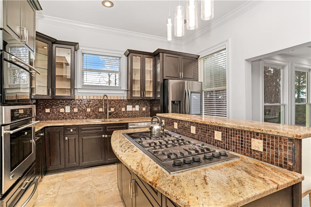 105 Ensley Point Fayetteville, GA 30214 - Photo 20 of 37 a kitchen with a stove a sink and a refrigerator