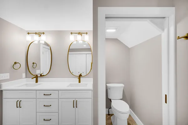 a bathroom with 2 sink and a mirror