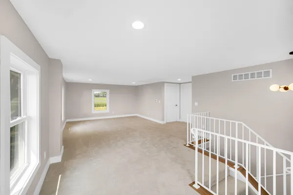 a view of a bedroom with wooden floor