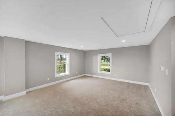 an empty room with windows and closet