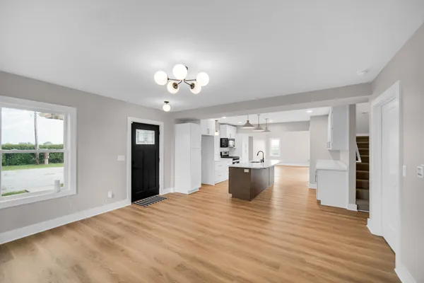 a view of a living room and kitchen with furniture window