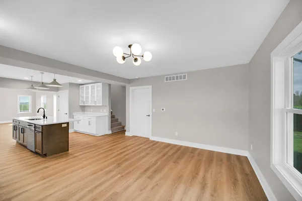 a view of a kitchen with microwave and cabinets