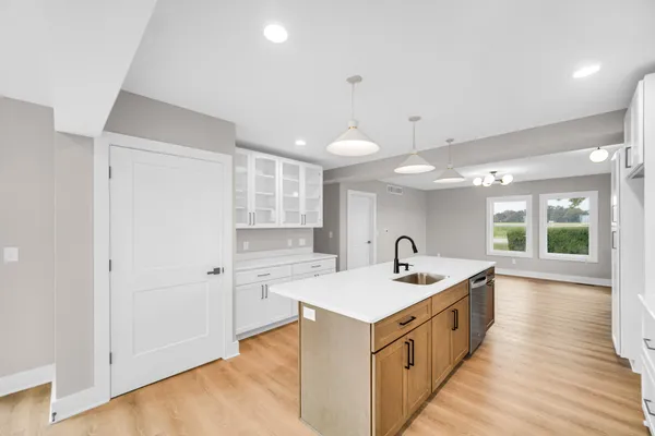 a kitchen with a sink and a stove top oven