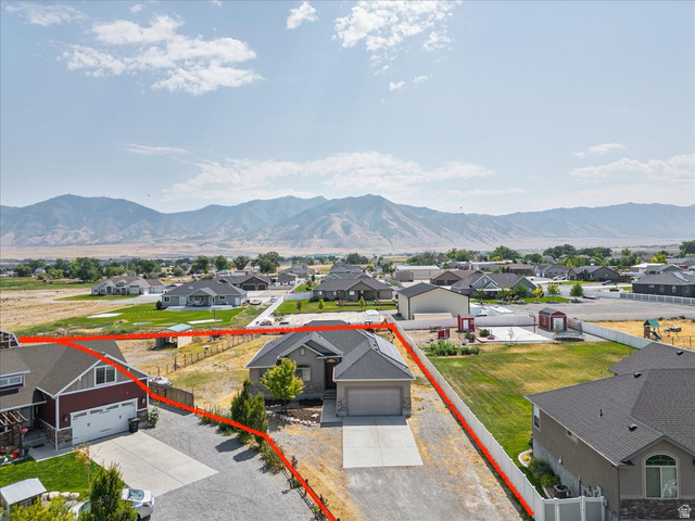 4364 Rose Springs Road Erda, UT 84074 - Photo 27 of 27 Aerial view of residential area with property parcel outlined and a mountain backdrop