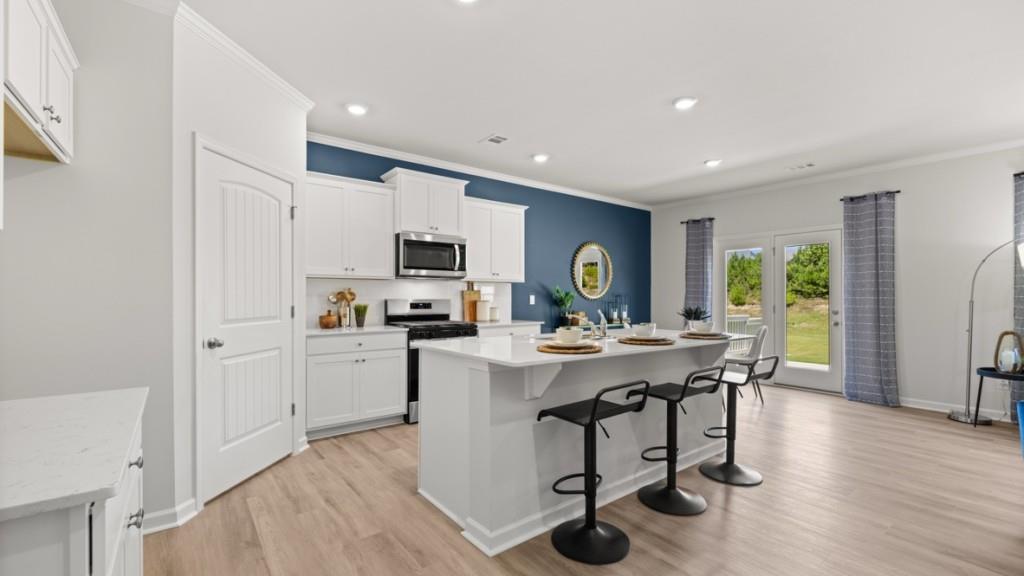 38 Rye Terrace Braselton, GA 30517 - Photo 5 of 33 a view of kitchen with kitchen island stainless steel appliances refrigerator stove dining table and chairs