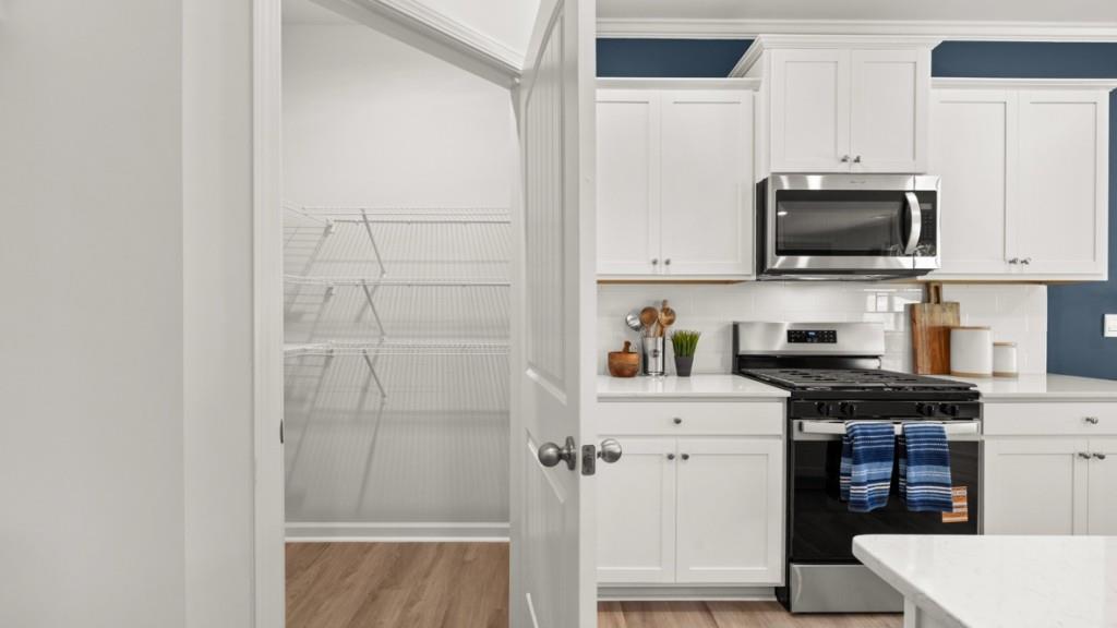 38 Rye Terrace Braselton, GA 30517 - Photo 10 of 33 a kitchen with stainless steel appliances a stove microwave and refrigerator