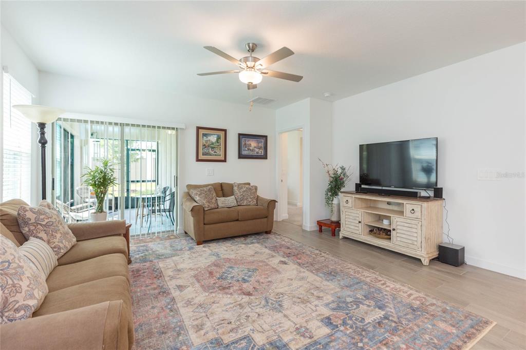 10806 Gable Dig Loop San Antonio, FL 33576 - Photo 9 of 73 a living room with furniture and a flat screen tv