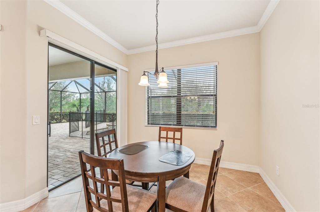 20345 Reale Circle Venice, FL 34293 - Photo 12 of 80 a view of a dining room with furniture window and outside view