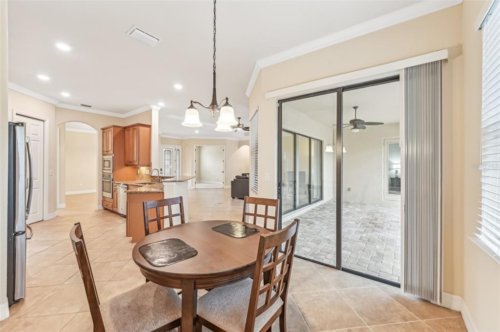 20345 Reale Circle Venice, FL 34293 - Photo 13 of 80 a view of a dining room with furniture window and wooden floor