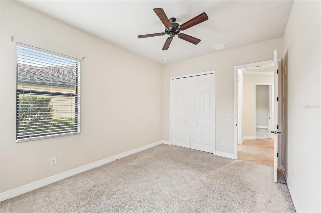 20345 Reale Circle Venice, FL 34293 - Photo 32 of 80 an empty room with a window and a ceiling fan