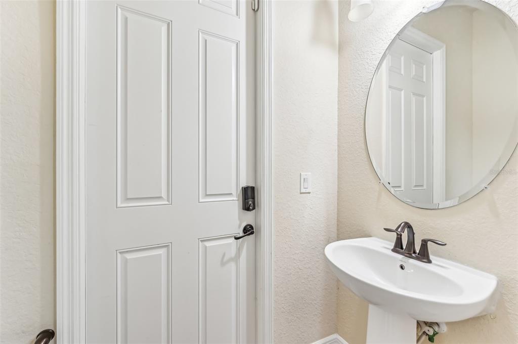 20345 Reale Circle Venice, FL 34293 - Photo 38 of 80 a bathroom with a sink a mirror and a toilet