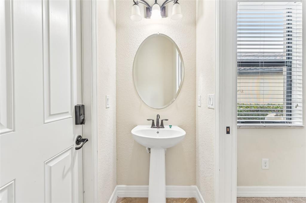 20345 Reale Circle Venice, FL 34293 - Photo 40 of 80 a bathroom with a sink a mirror and a window