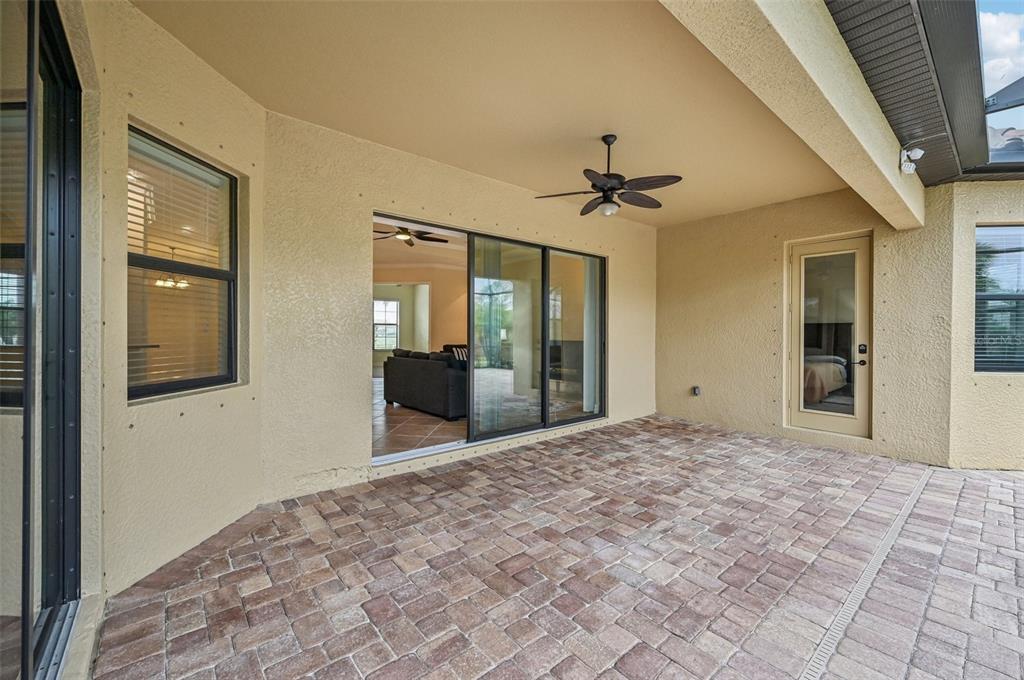 20345 Reale Circle Venice, FL 34293 - Photo 49 of 80 a view of a hallway with a chandelier fan and windows