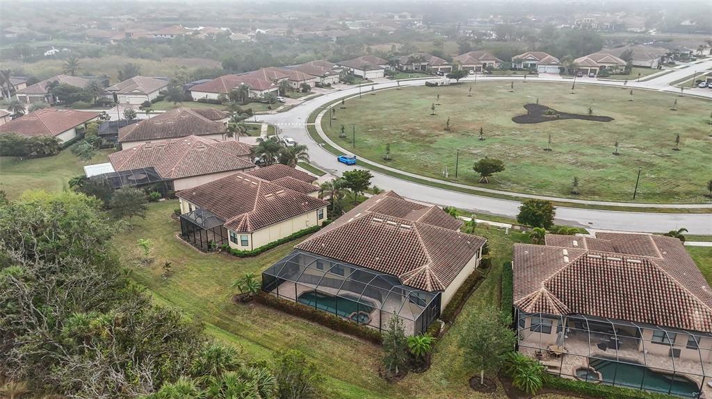 20345 Reale Circle Venice, FL 34293 - Photo 66 of 80 an aerial view of a house with outdoor space and a lake view in back