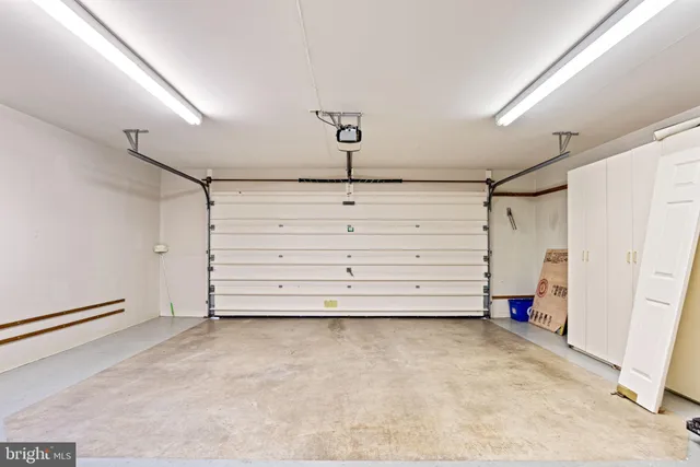 a front view of a house with a yard and a garage