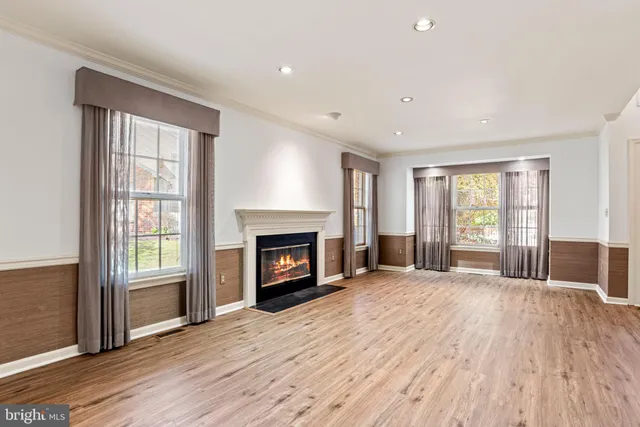 a view of workspace with wooden floor and windows