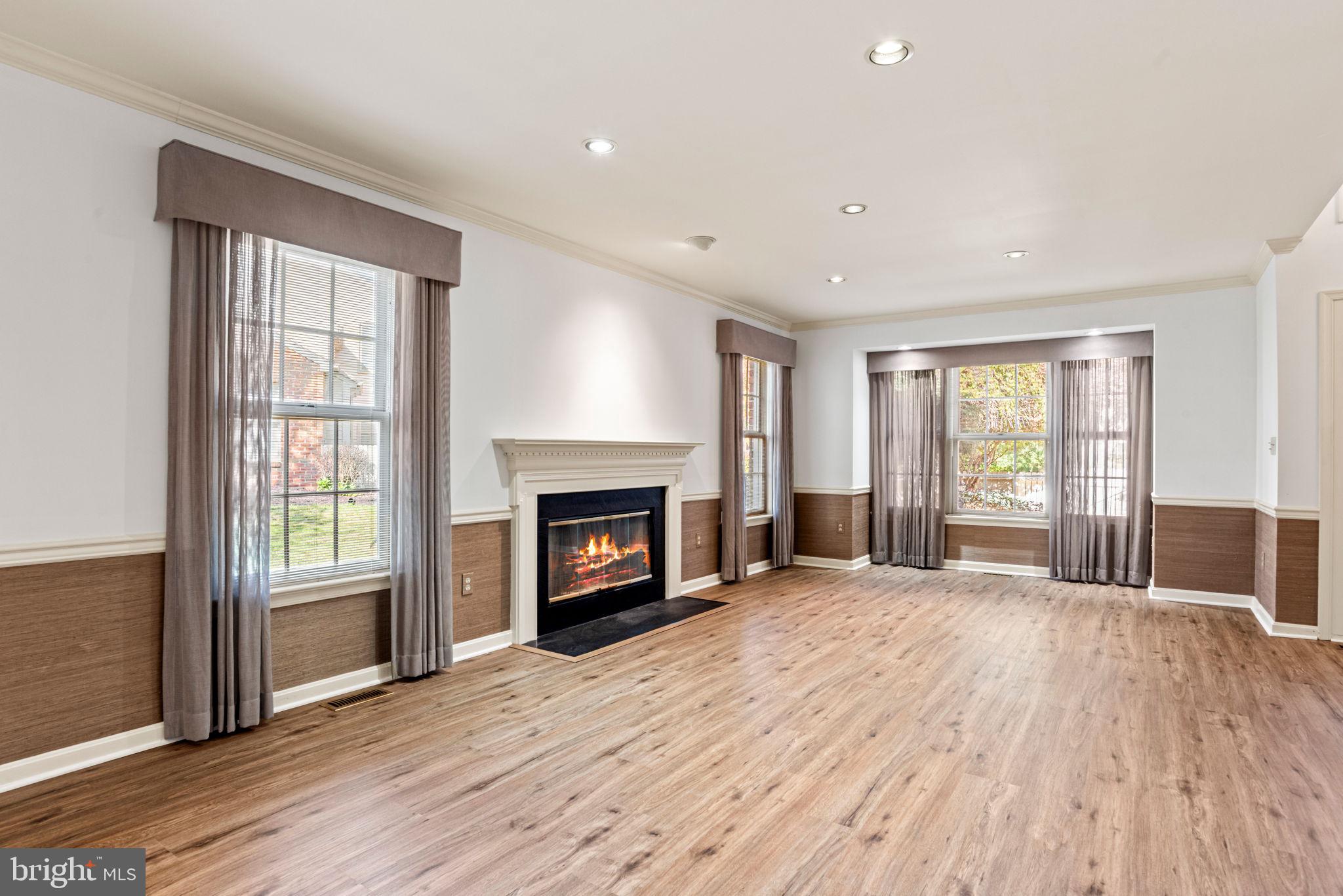 72 Leearden Road Hershey, PA 17033 - Photo 10 of 53 an empty room with windows fireplace and wooden floor