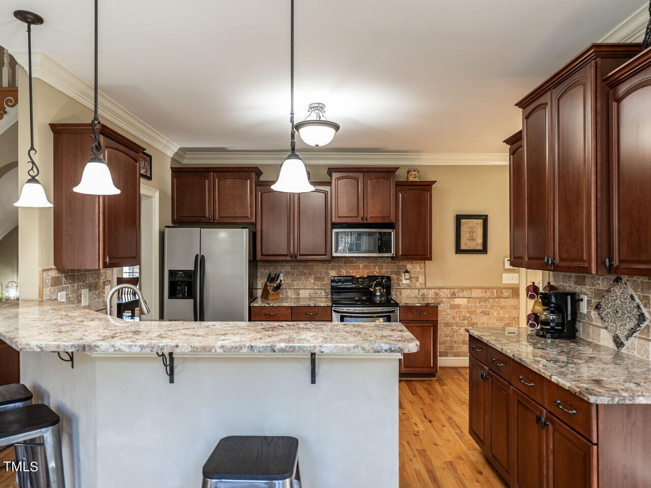 1173 Smith Creek Way Wake Forest, NC 27587 - Photo 14 of 42 a kitchen with stainless steel appliances a sink stove and cabinets