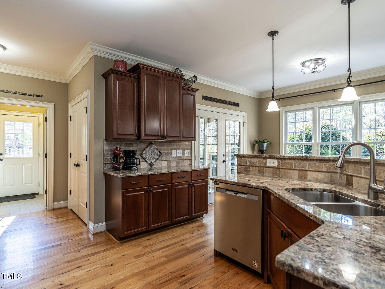 1173 Smith Creek Way Wake Forest, NC 27587 - Photo 15 of 42 a kitchen with stainless steel appliances granite countertop a sink a stove and a wooden floors
