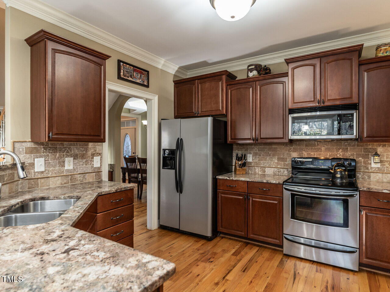1173 Smith Creek Way Wake Forest, NC 27587 - Photo 17 of 42 a kitchen with stainless steel appliances granite countertop a refrigerator stove and sink