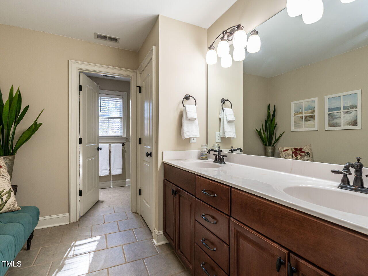 1173 Smith Creek Way Wake Forest, NC 27587 - Photo 27 of 42 a spacious bathroom with a double vanity sink a mirror and a shower