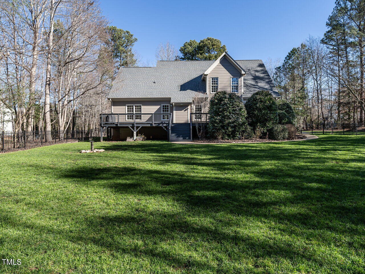 1173 Smith Creek Way Wake Forest, NC 27587 - Photo 36 of 42 a view of a big house with a big yard and large trees