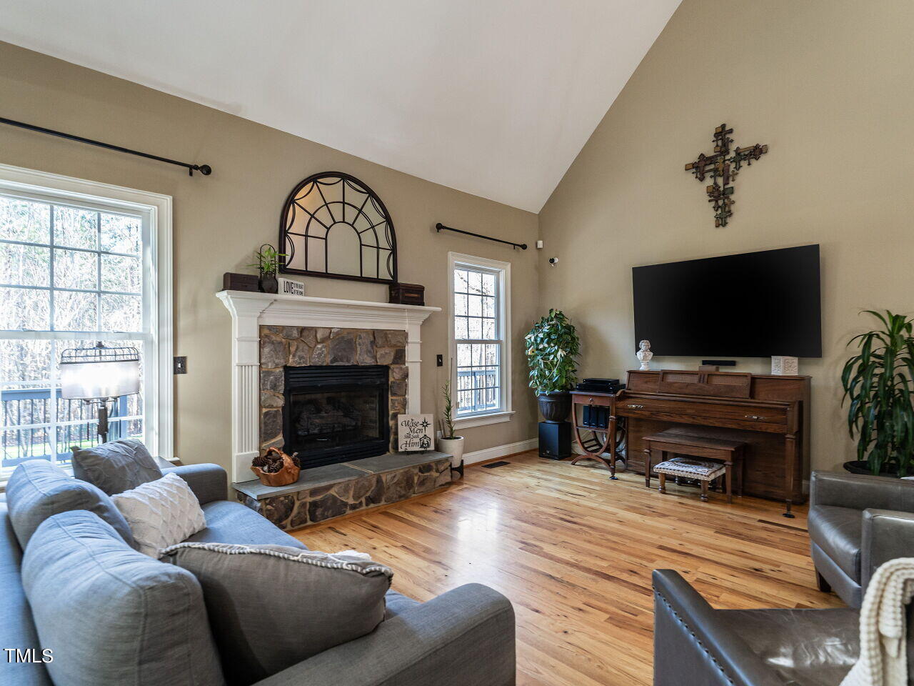 1173 Smith Creek Way Wake Forest, NC 27587 - Photo 10 of 42 a living room with furniture a flat screen tv and a fireplace