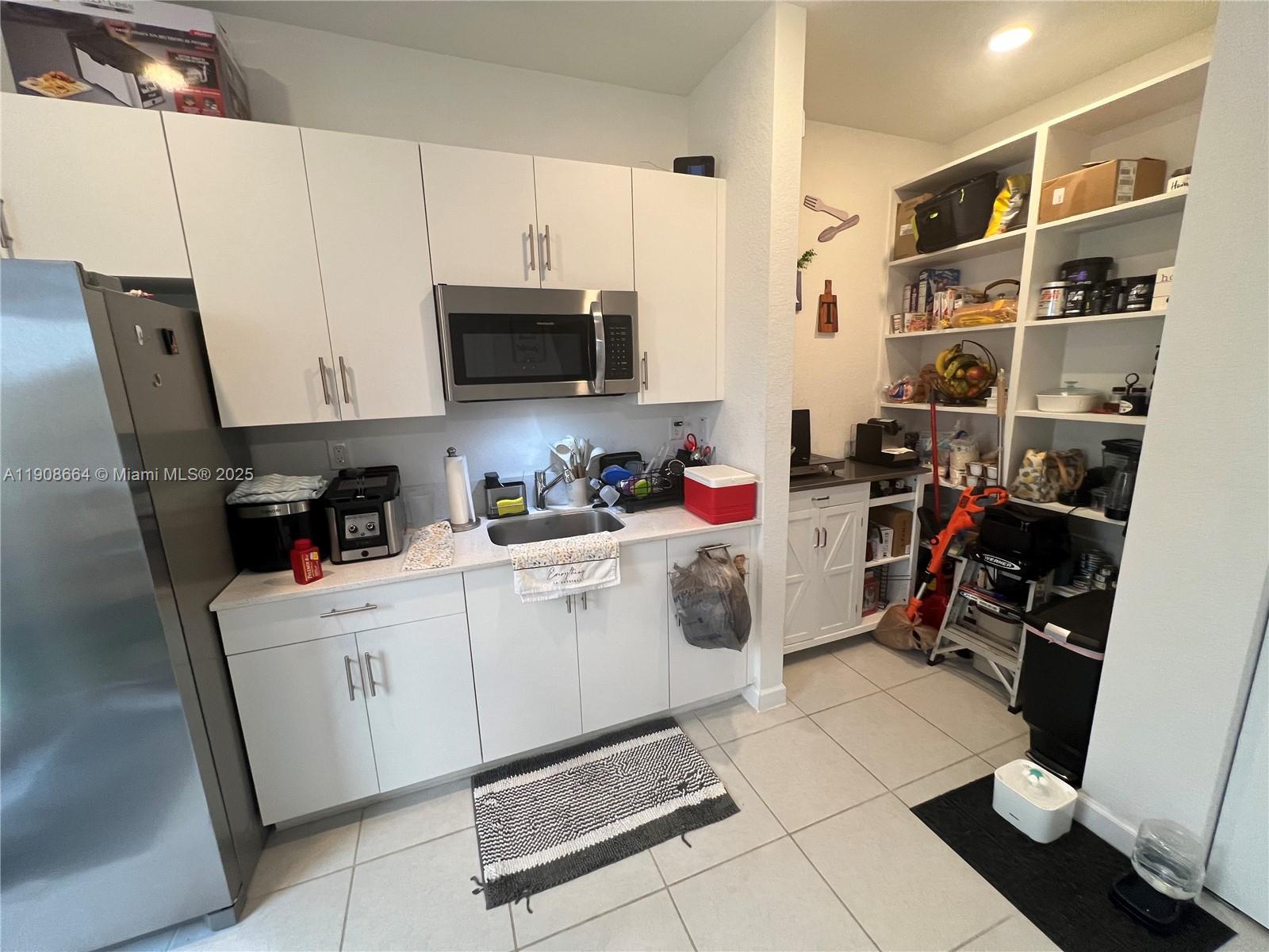 a room with a white cabinets and appliances