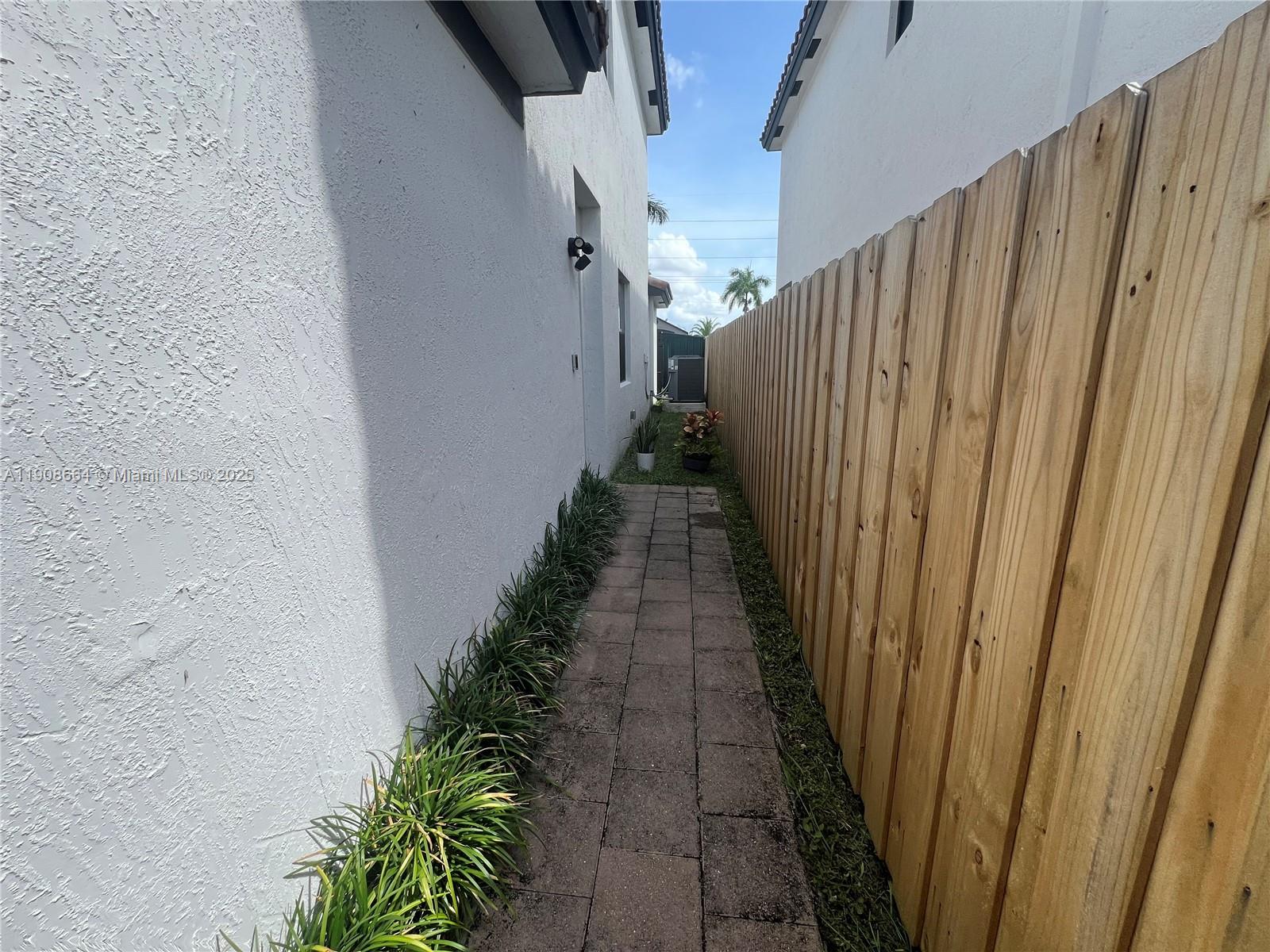 11751 Southwest 248th Terrace Homestead, FL 33032 - Photo 12 of 14 a view of a pathway with a white door