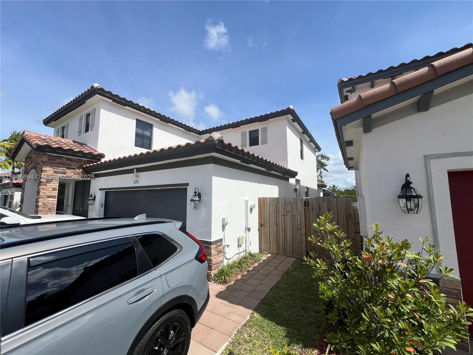 11751 Southwest 248th Terrace Homestead, FL 33032 - Photo 14 of 14 a view of a house with a yard and potted plants