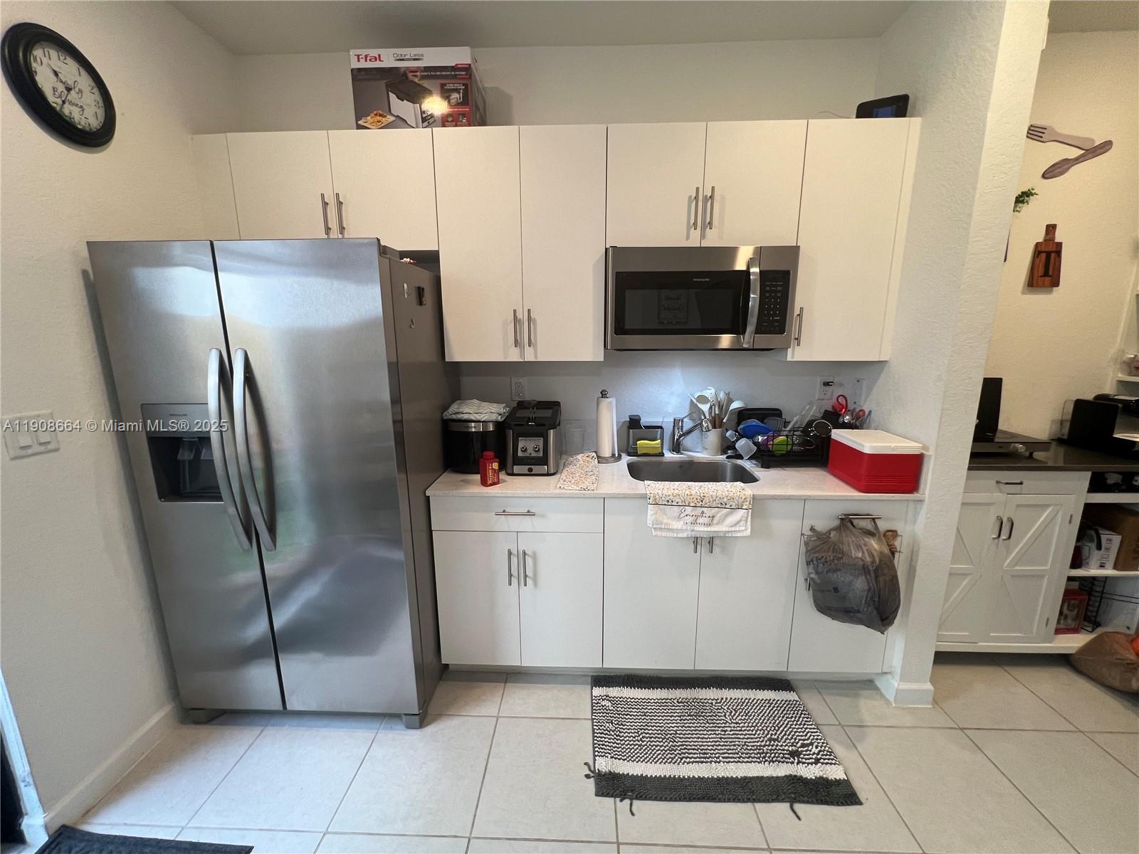 11751 Southwest 248th Terrace Homestead, FL 33032 - Photo 2 of 14 a kitchen with stainless steel appliances a refrigerator sink and microwave