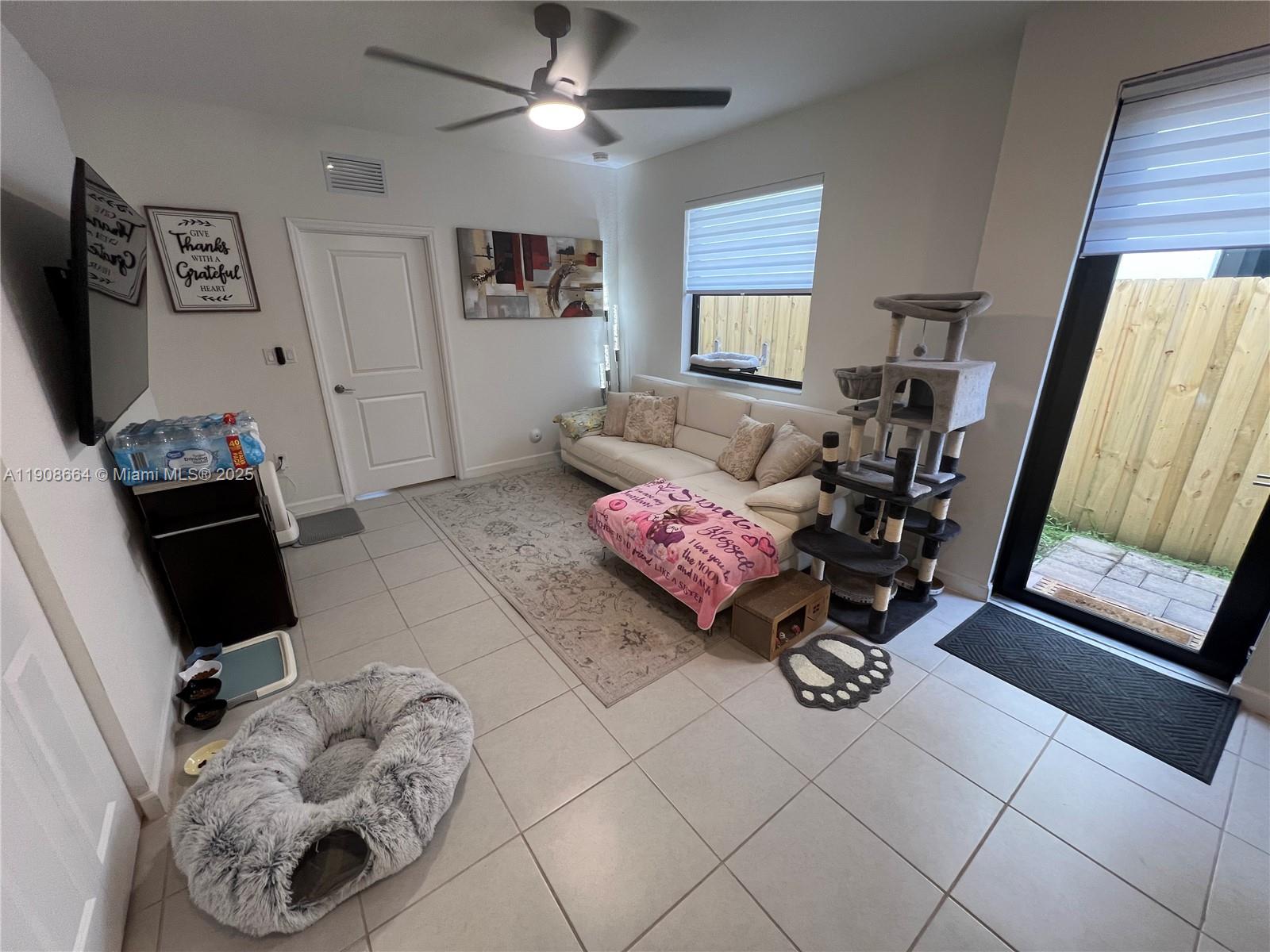 11751 Southwest 248th Terrace Homestead, FL 33032 - Photo 3 of 14 a living room with furniture and a flat screen tv