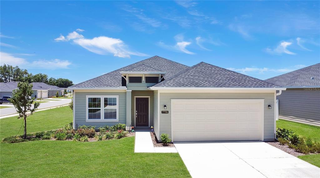 a front view of a house with a garden
