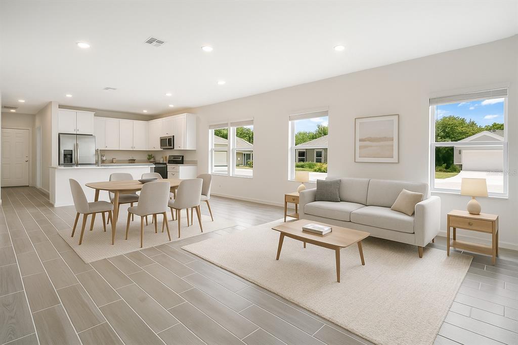 7796 Southwest 74th Loop Ocala, FL 34481 - Photo 2 of 20 a living room with furniture and a dining table with wooden floor