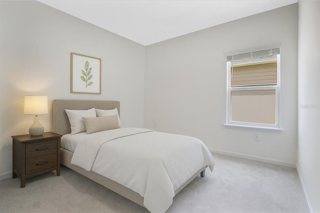 7796 Southwest 74th Loop Ocala, FL 34481 - Photo 8 of 20 a bedroom with a bed and a lamp on dresser