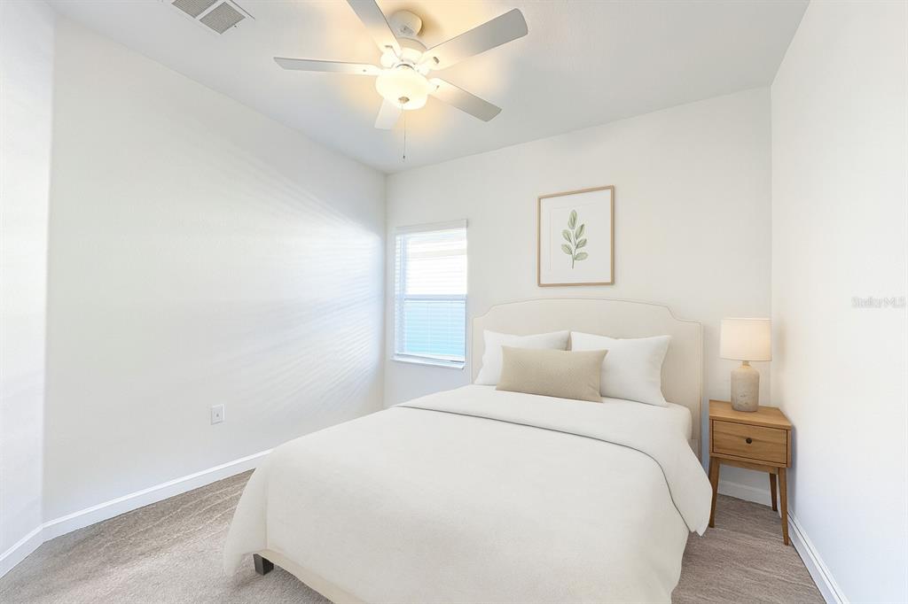 7796 Southwest 74th Loop Ocala, FL 34481 - Photo 9 of 20 a bedroom with a bed and a chandelier