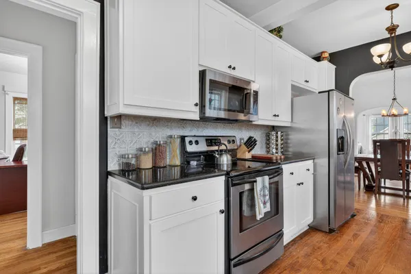 a kitchen with stainless steel appliances granite countertop a stove a sink and a refrigerator