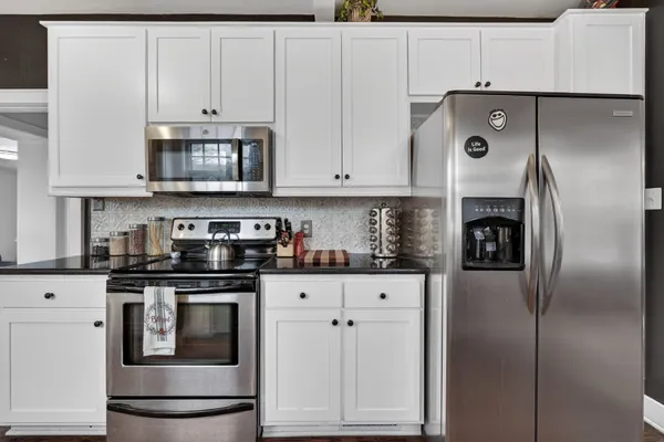 a kitchen with cabinets and stainless steel appliances