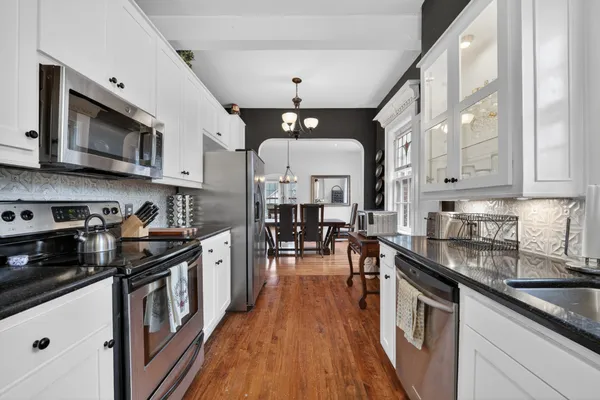 a kitchen with stainless steel appliances granite countertop a stove and a sink