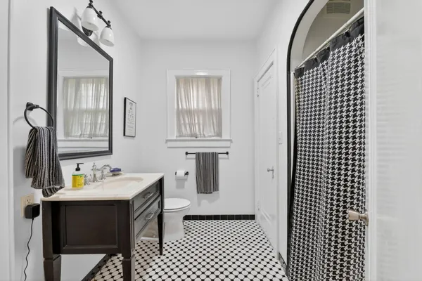 a bathroom with a sink toilet and mirror