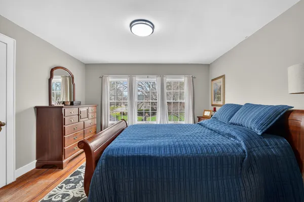 a bed sitting in a bedroom next to a window