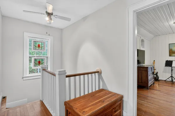 a view of a hallway with workspace and a window